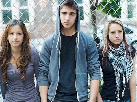 simsearch:877-06833900,k - 3 teenagers leaning against chain link fence Stock Photo - Rights-Managed, Code: 877-06833968