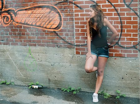 Teenage girl leaning against wall Stock Photo - Rights-Managed, Code: 877-06833975