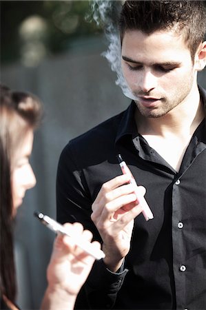 smoking women - France, young couple smoking electronic cigarettes. Stock Photo - Rights-Managed, Code: 877-07460573