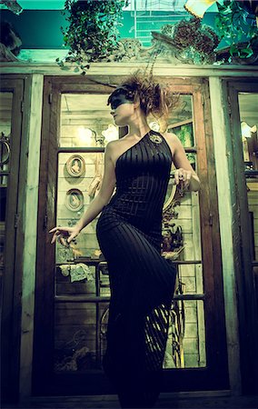 fashion full body woman not male - Woman standing in profile in black dress Stock Photo - Rights-Managed, Code: 877-07460624