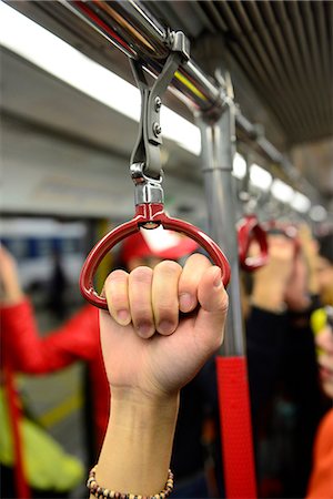 People holding on to a handle on a train in Hong Kong subway,China Stock Photo - Rights-Managed, Code: 877-08026551