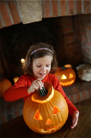 fireplace autumn - Little girl with a Jack-o-lantern Stock Photo - Rights-Managed, Code: 877-08031305