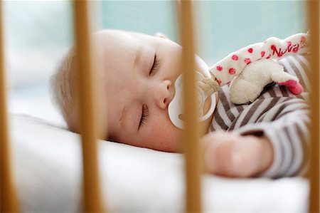 soft toy bed - Baby boy slipping in his crib Stock Photo - Rights-Managed, Code: 877-08031323