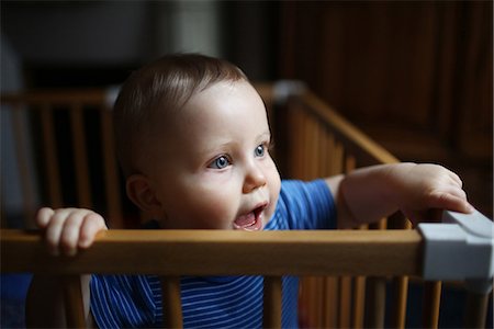 A 10 months baby boy standing in his playpen Stock Photo - Rights-Managed, Code: 877-08079029