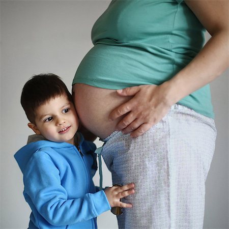 family in pajamas - A little boy next to her belly pregnant mom Stock Photo - Rights-Managed, Code: 877-08079088