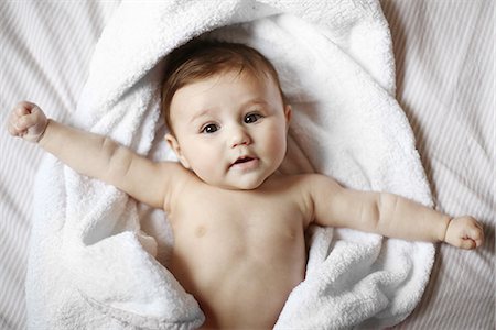 person laying in a tub - Portrait of a 4 months old baby naked in a towel Stock Photo - Rights-Managed, Code: 877-08079171