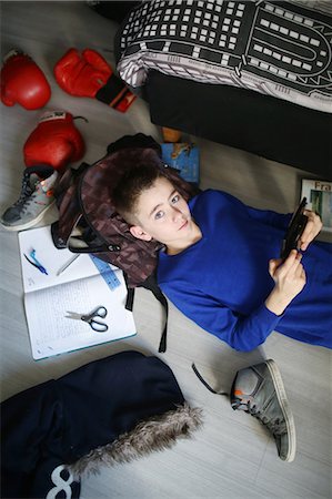 school boy with bag - A 10 years old boy playing with his game console in his bedroom Stock Photo - Rights-Managed, Code: 877-08079224