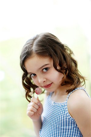 Portrait of a 8 years old girl with a lollipop Stock Photo - Rights-Managed, Code: 877-08127887