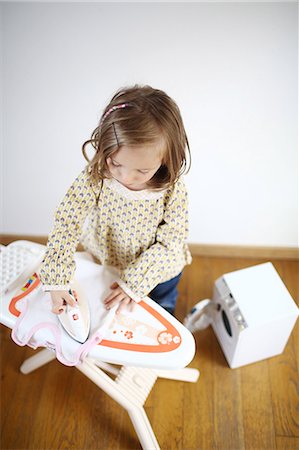 simsearch:877-08128232,k - A 3 years old girl playing with an iron and ironing board for child Stock Photo - Rights-Managed, Code: 877-08128231