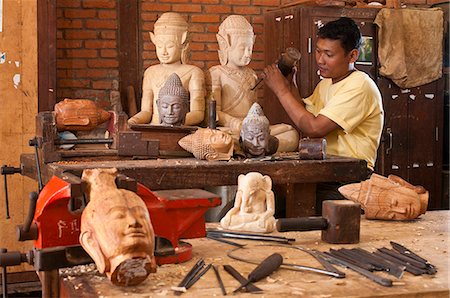 Camdodia, Siem Reap Province, Siem Reap Town, craft workshop, a sculptor works on an evea wood piece from Ratanakiri Stock Photo - Rights-Managed, Code: 877-08128265