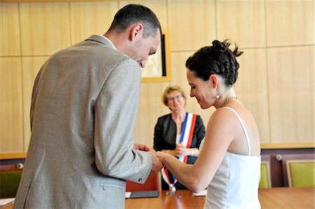 France, Western France, wedding of a young couple man woman in Saint-Gilles-Croix-de-Vie City Hall, Mayor with French tricolor scarf, exchange of rings, marriage. Stock Photo - Rights-Managed, Code: 877-08898103