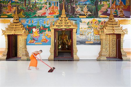 Laos, Vientiane, Buddhist monk cleaning the ground at the entrance of Mixay temple Stockbilder - Lizenzpflichtiges, Bildnummer: 877-08898112