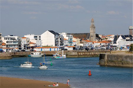 simsearch:6108-08637221,k - France, Pays de la Loire, Vendee, Saint-Gilles-Croix-de-Vie, port entrance, Sainte Croix church in the background Stock Photo - Rights-Managed, Code: 877-08898266