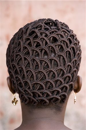 A woman's head with braided patterned hair and earrings. Photographie de stock - Rights-Managed, Code: 878-07442662