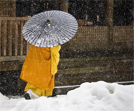 A Bhuddist monk walks through a snow flurry in Koyasan, a centre for Shingon Esoteric Buddhism. Stock Photo - Rights-Managed, Code: 878-07442712