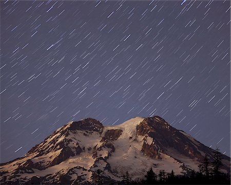 day to night - A five minute timed exposure of the night sky and a shower of stars above Mount Rainier in Mount Rainier national park in the Cascade Mountains range, Washington, USA Stock Photo - Rights-Managed, Code: 878-07442730