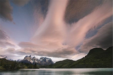 Cloud formations in the skies above the Torres del Paine National Park in Chile. Sunset over the waters of the sea, and snowcapped peaks. Stockbilder - Lizenzpflichtiges, Bildnummer: 878-07442777