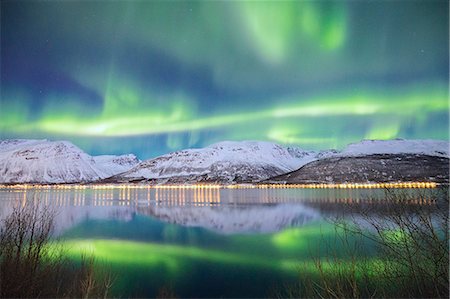 Northern Lights is reflected in Kafjorden. Kafjorden, Lyngen Alps, Troms, Norway, Lapland, Europe. Stock Photo - Rights-Managed, Code: 879-09020897