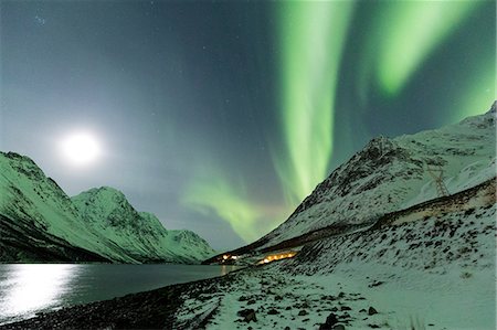 simsearch:6129-09044279,k - Northern Lights color the night sky lit up by the moon. Kjosenfjord, Lyngen Alps, Troms, Norway, Lapland, Europe. Stock Photo - Rights-Managed, Code: 879-09020906