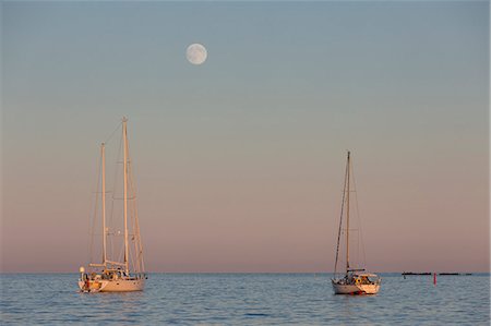 sailboat sunset - Mooring aailboats during the sunset (Lerins Islands, Cannes, Grasse, Alpes-Maritimes department, Provence-Alpes-Cote d'Azur region, France, Europe) Stock Photo - Rights-Managed, Code: 879-09021005