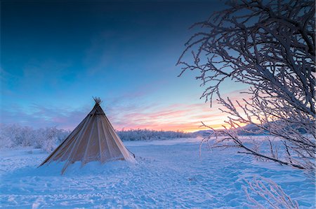 Pink sky at sunrise on isolated Sami tent in the snow, Abisko, Kiruna Municipality, Norrbotten County, Lapland, Sweden Stock Photo - Rights-Managed, Code: 879-09021262