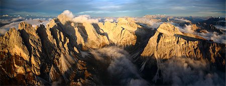 Aerial view of the mountain range of Odle surrounded by clouds. Dolomites Val Funes Trentino Alto Adige South Tyrol Italy Europe Stock Photo - Rights-Managed, Code: 879-09034097