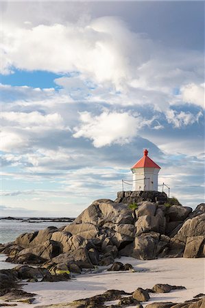 Midnight sun lights up lighthouse on cliffs surrounded by turquoise sea Eggum Unstad Vestvagøy Lofoten Islands Norway Europe Stock Photo - Rights-Managed, Code: 879-09034293