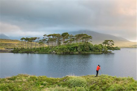 simsearch:879-09033333,k - Photographer in front of Pine Island on Derryclare Lake. Connemara, Co. Galway, Connacht province, Ireland. Stock Photo - Rights-Managed, Code: 879-09033344