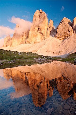 Tre Cime di Lavaredo, Sexten dolomites, Trentino-Alto Adige, Italy. The Three peaks of Lavaredo are reflected into the small lake at sunset, near Locatelli refuge Stock Photo - Rights-Managed, Code: 879-09033381