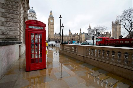 A tipical red phone booth of London with Big Ben in background on a rainy day. London, England Stock Photo - Rights-Managed, Code: 879-09033452