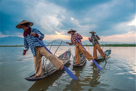 shan state - Inle lake, Nyaungshwe township, Taunggyi district, Myanmar (Burma). Thee local fishermen rowing in row. Stock Photo - Rights-Managed, Code: 879-09033492