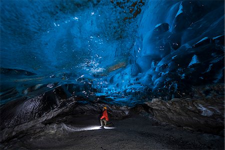 Man inside an ice caver under the Vatnajokull glacier, Vatnajokull national park, East Iceland, Iceland (MR) Stock Photo - Rights-Managed, Code: 879-09033516