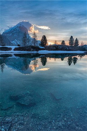 simsearch:879-09033588,k - Europe, Italy, Veneto, Falzarego, Belluno. Morning view of the Tofana di Rozes reflected in the calm water of the Limedes lake, Dolomites Stock Photo - Rights-Managed, Code: 879-09033584