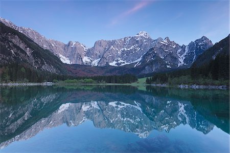 forest and mountain in europe - Europe, Italy, Friuli Venezia Giulia. Dusk at the Fusine upper lake with the Mangart mount on background Stock Photo - Rights-Managed, Code: 879-09033605