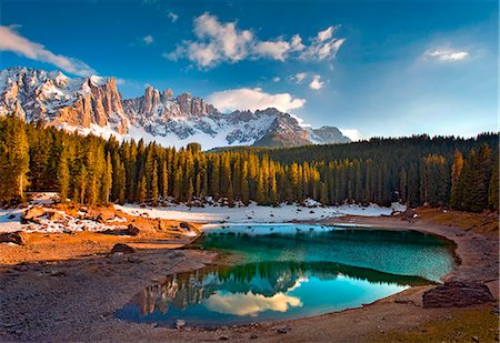 forst - Dolomites. The Carezza lake, with fir forests and the Latemar ridge in the background, at sunset Stockbilder - Lizenzpflichtiges, Bildnummer: 879-09033750