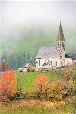 simsearch:879-09128889,k - Church surrounded by autumnal trees and mist. Santa Maddalena, Funes, Bolzano, Trentino Alto Adige - Sudtirol, Italy, Europe. Stock Photo - Rights-Managed, Code: 879-09043479