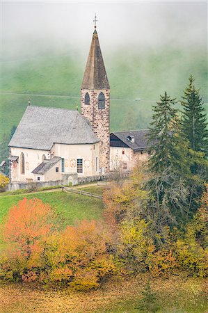 simsearch:879-09128889,k - Church surrounded by autumnal trees and mist. Santa Maddalena, Funes, Bolzano, Trentino Alto Adige - Sudtirol, Italy, Europe. Stock Photo - Rights-Managed, Code: 879-09043480