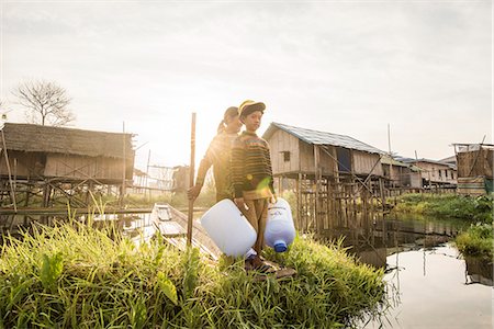 Inle lake, Nyaungshwe township, Taunggyi district, Myanmar (Burma). Girl and a child on a boat between the floating houses on the lake. Stock Photo - Rights-Managed, Code: 879-09043631