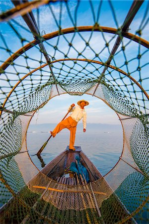 Inle lake, Nyaungshwe township, Taunggyi district, Myanmar (Burma). Local fisherman through the typical conic fishing net. Stock Photo - Rights-Managed, Code: 879-09043633