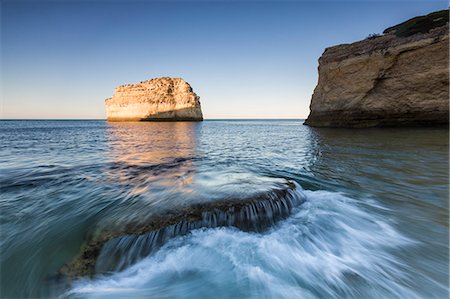 simsearch:879-09190989,k - Ocean waves crashing on rocks at sunrise Praia De Albandeira Carvoeiro Caramujeira Lagoa Municipality Algarve Portugal Europe Stock Photo - Rights-Managed, Code: 879-09043906