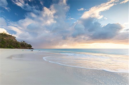 pink beach sunset - The sky turns pink at sunset and reflected on Ffryers Beach Caribbean Antigua and Barbuda Leeward Islands West Indies Photographie de stock - Rights-Managed, Code: 879-09043911