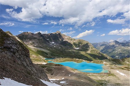 simsearch:879-09191256,k - Clouds and sun on turquoise lakes framed by rocky peaks Joriseen Jörifless Pass canton of Graubünden Engadin Switzerland Europe Stock Photo - Rights-Managed, Code: 879-09043944