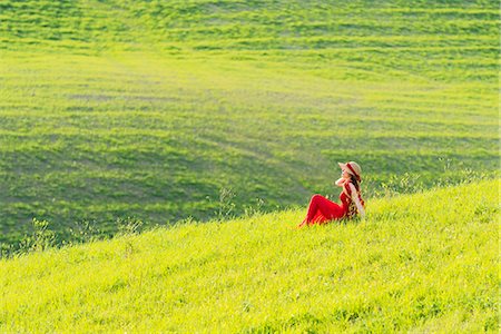 simsearch:879-09100804,k - San Quirico d'Orcia, Orcia valley, Siena, Tuscany, Italy. A young woman in red dress is sitting in a wheat field Stock Photo - Rights-Managed, Code: 879-09099971