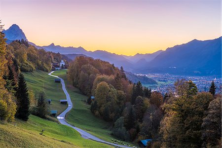 forest and mountain in europe - Wamberg, Garmisch Partenkirchen, Bavaria, Germany, Europe. Wamberg village at dusk. Garmisch Partenkirchen and Zugspitze mountain in the background Stock Photo - Rights-Managed, Code: 879-09099989