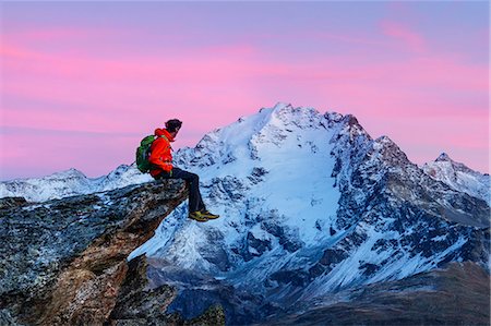 simsearch:879-09100329,k - An hiker on a rock admiring Piazzi peak at sunset. Valdidentro, Valtellina, Lombardy, Italy Fotografie stock - Rights-Managed, Codice: 879-09100358