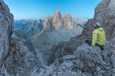 Hiker on the top of mount Paterno / Paternkofel looking the sunrise towards Tre Cime di Lavaredo, Sexten Dolomites, South Tyrol, Bolzano, Italy Photographie de stock - Rights-Managed, Code: 879-09100470