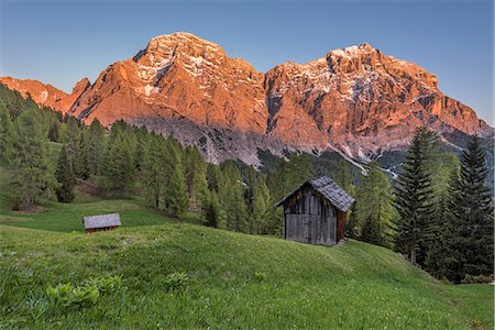 rock mountains - La Valle / Wengen, Alta Badia, Bolzano province, South Tyrol, Italy. Sunset on the pastures of Pra de Rit with the peaks Cima Nove / Neunerspitze and Cima Dieci / Zehnerspitze Stock Photo - Rights-Managed, Code: 879-09100581