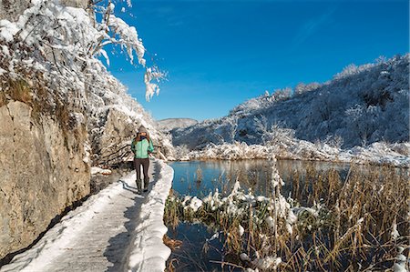 Woman on a wooden walkway of Plitvice Lakes National Park, Plitvicka Jezera, Lika and Senj County, Croatia Stock Photo - Rights-Managed, Code: 879-09128990