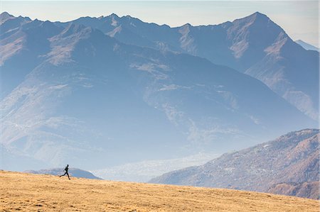 simsearch:879-09129195,k - Runner on the slopes of Scermendone with Orobie Alps on background, Valtellina, province of Sondrio, Lombardy, Italy Stock Photo - Rights-Managed, Code: 879-09129194