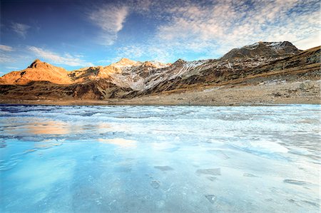 simsearch:879-09129253,k - Frozen lake Montespluga at dawn, Chiavenna Valley, Sondrio province, Valtellina, Lombardy, Italy Stock Photo - Rights-Managed, Code: 879-09129252